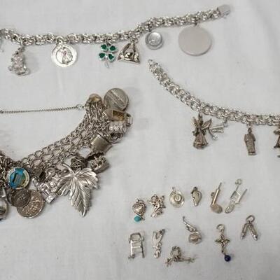 1013	LOT OF THREE CHARM BRACELETS W/ STERLING SILVER CHAINS & CHARMS (SOME CHARMS ARE NOT MARKED STERLING) TOTAL WEIGHT INCLUDING ALL...