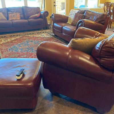 Leather sofa, love seat and chair/ottoman, with nailhead trim.