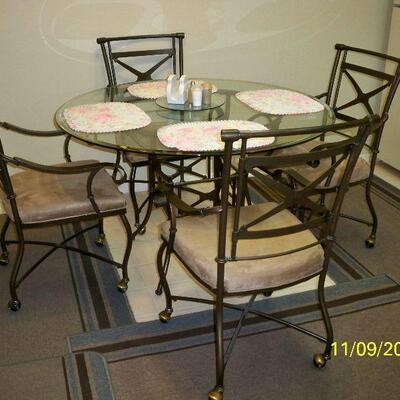 Metal Table with glass top and 4 chairs on casters