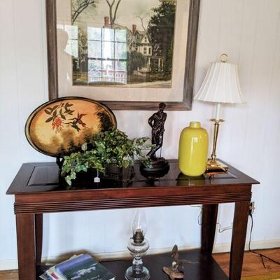Contemporary sofa table with shelf and beveled glass top and accessories