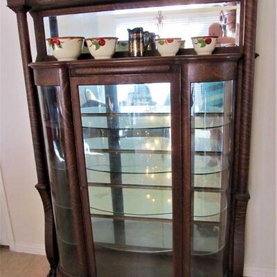 1900's Stunning curio cabinet with curved glass doors.