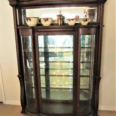 1900's Stunning curio cabinet with curved glass doors.