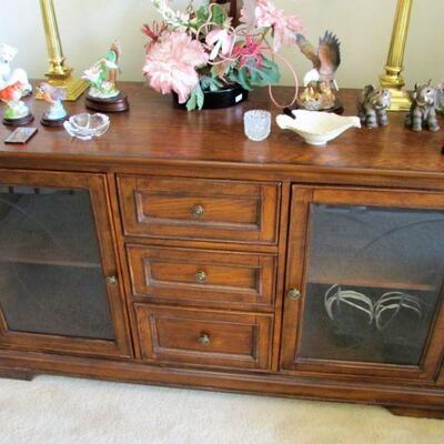 Nice entertainment center with glass doors and drawer storage.