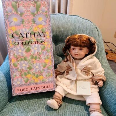 This sweet lifelike doll has a ceramic face, hands, and feet with a huggable cloth body.  For 8 years old and up.  Really nice condition...
