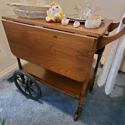 This is a very old tea cart with great wooden wheels.  It was made by the Geo. Bilton Co. in Toronto.  Special deal for Vinta Gee Estate...