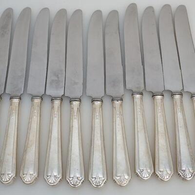11 Sterling Handle Dinner Knives in the 1928 Modern Colonial Pattern designed by Axel Staf and Made by Alvin/Gorham. Each 9 5/8