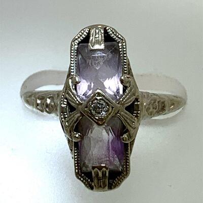 One 14kt white gold antique style diamond & amethyst ring. The ring features one (1), bead set, old mine cut  diamond set in the center...