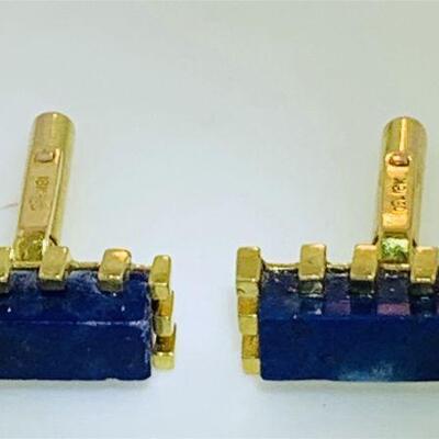 Pair of 18kt gold lapis cuff links. The cuff links each feature one (1), prong set, rectangular shape onyx set in the center. The cuff...