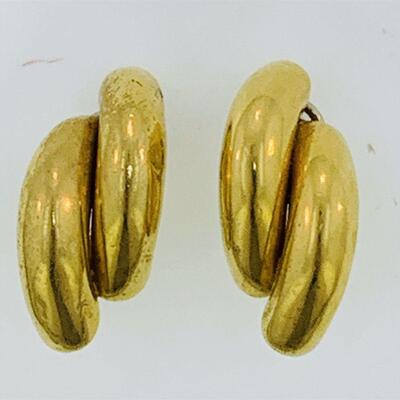 Pair of 18kt gold double elbow style clip on earrings. The earrings measure approx. 35.90 x 16.40mm, have clip on omega backs, a high...