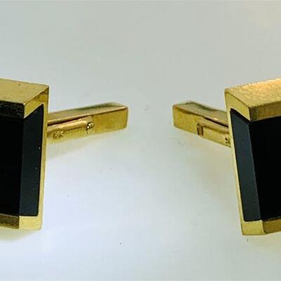 Pair of 18kt gold onyx cuff links. Each cuff link features one (1), channel set, square onyx in the center. The cuff links measure...