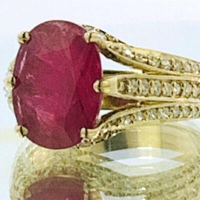 One 14kt gold ruby & diamond ring. The ring features one (1), six prong set, oval faceted ruby in the center accented with a total of...