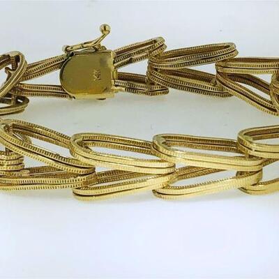 One 14kt gold fancy link design bracelet. The bracelet features 
