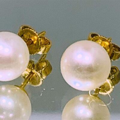 One pair of 18kt gold cultured pearl earrings. Each earring features one (1), half drilled, near round cultured pearl which measures 2@...