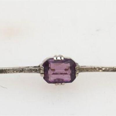 
Antique style 14kt white gold stick pin style amethyst brooch. The brooch features one (1), four multi-prong set, emerald step cut...