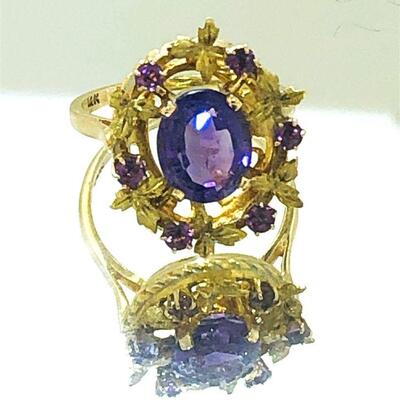 14kt gold amethyst open design dinner ring. The ring features one (1), four prong set, oval faceted amethyst set in the center accented...