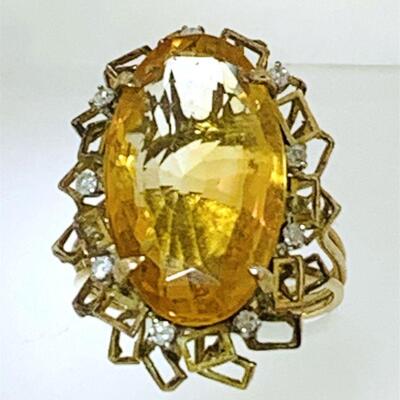 Large 14kt gold citrine & diamond cocktail ring. The ring features one (1), prong set, oval faceted citrine set in the center with nine...