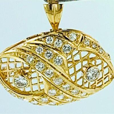 One 14kt gold diamond marquise shape brooch/pendant. The piece features two (2), bezel set, round brilliant cut diamonds set within a...