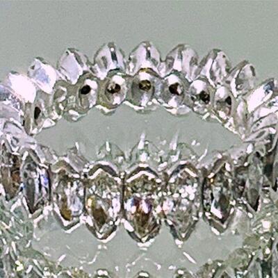 One platinum diamond eternity band (size 7). The band features a total of twenty-three (23), V- tip prong set, marquise cut diamonds...