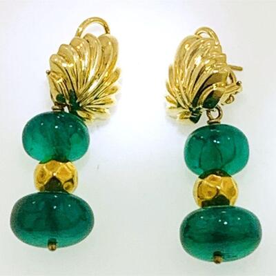 Very unique pair of 18kt gold & emerald dangle earrings. The detachable tops of the earrings have a scalloped design and leaver clip on...