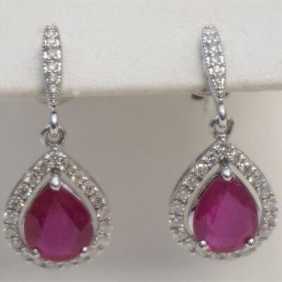 Pair of 14kt white gold ruby & diamond dangle style earrings. Each earring features one (1), prong set, pear shape faceted ruby...