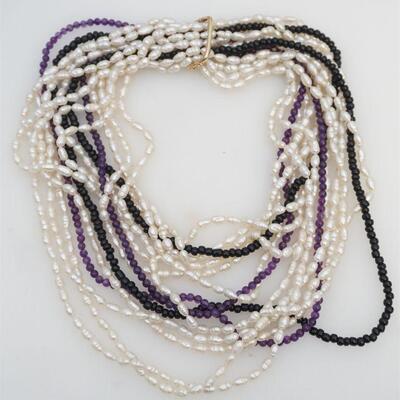 This lot features five strands of seed pearls, one strand of round onyx beads, and one strand of round amethyst beads; accompanied by a...