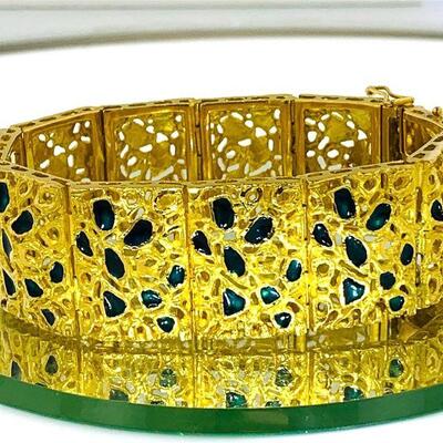 One 18kt gold elaborate enamel accented open link bracelet. The bracelet has a link design with rectangular links each accented by a fine...