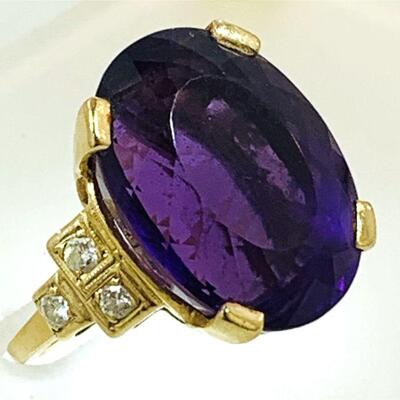 Large 14kt gold amethyst & diamond cocktail ring. The ring features one (1), four prong set, oval faceted amethyst set in the center with...