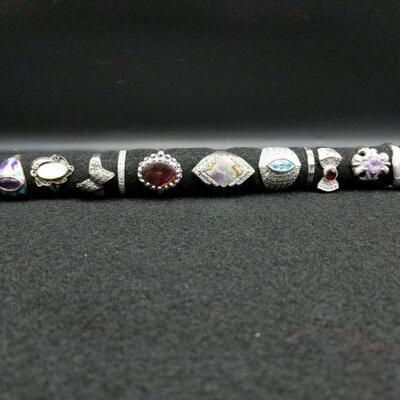 15 Rings which are all approximately sizes 7 1/2 and 8. Total weight of rings to include their stones is 2.5 oz.

 
