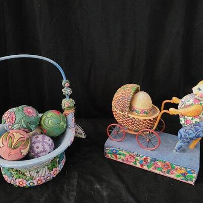 Jim Shore is known for his beautifully handcrafted and painted pieces. Mother rabbit pushing her baby, basket full of spring time beauty....