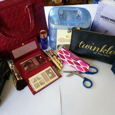 Jewelry organizer, manicure set x2, Estee Lauder set (untouched) with brushes, and fancy bags.

 