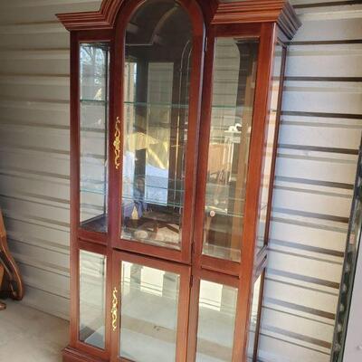 https://ctbids.com/#!/description/share/687792 Lighted curio cabinet in cherry finish. Has 3 adjustable glass shelves with plate routing....