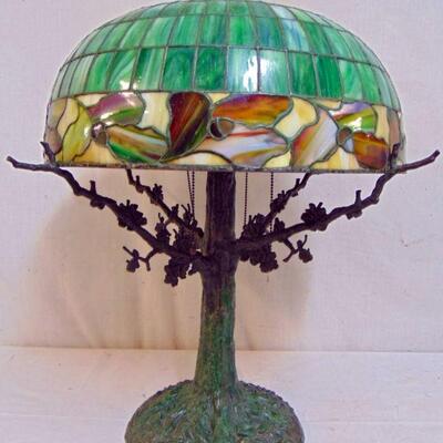 Fine quality leaded dome glass table lamp on rustic tree trunk with branches style base, of the period, not a reproduction