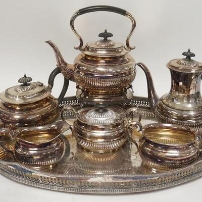 1009	ENGLISH SEVEN PIECE SILVERPLATED TEA & COFFEE SET. POT ON STAND IS 12 IN H TRAY W/ PIERCED GALLERY IS 22 1/4 IN X 15 3/4 IN 
