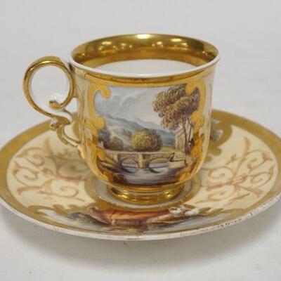 1005	ANTIQUE SPODE HAND PAINTED SCENIC CUP & SAUCER DESCRIPTIONS OF THE SCENES ARE WRITTEN IN SCRIPT ON THE BASES. SAUCER IS 6 IN DIAMETER 
