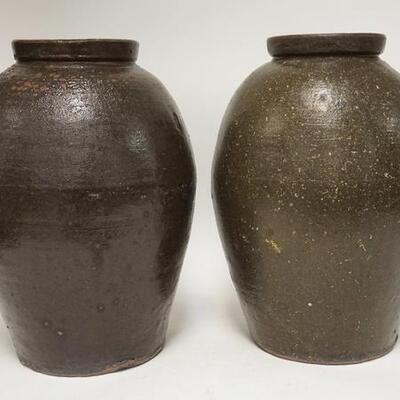 1020	PAIR OF BROWN GLAZED FLOOR URNS W/ ROUGH TEXTURED SURFACE 17 1/4 IN H HOLES & IN BASES FOR DRAINAGE 
