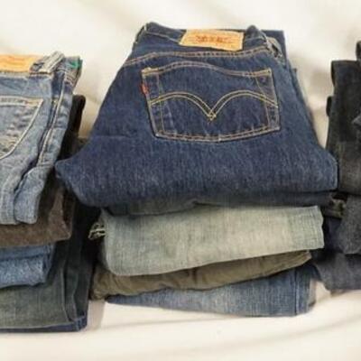 1153	LOT OF 18 PAIRS OF LEVI'S JEANS. INCLUDING THREE ORANGE & ONE BLACK TAB. ALL HAVE 28 IN WAIST. VARYING DEGREES OF WEAR 

