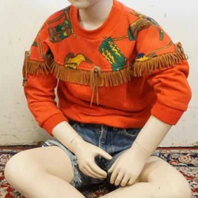 1181	MALE MANNEQUIN CLOTHED WITH VINTAGE SELVEDGE JEANS THAT ARE CUT OFF INTO SHORTS, VINTAGE MILTON FUN WEAR FRINGED PULL OVER SHIRT AND...