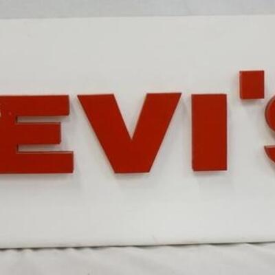 1218	LEVIS LIGHT UP SIGN, DOES NOT LIGHT UP. SOME DAMAGE TO LETTERING ON FRONT 30 IN L 12 1/4 IN H 
