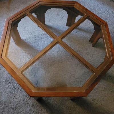 https://ctbids.com/#!/description/share/697695 This is an 8 sided wooden table with a glass top. It is 16