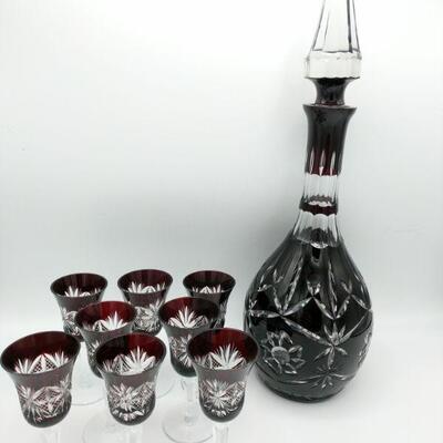 https://ctbids.com/#!/description/share/697688 This is a beautiful red cut crystal decanter set with 8 aperitif glasses. The decanter...