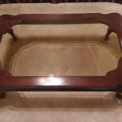 https://ctbids.com/#!/description/share/700655 Coffee table is wood with glass top fitted to form to the curves. Trimming around tables...