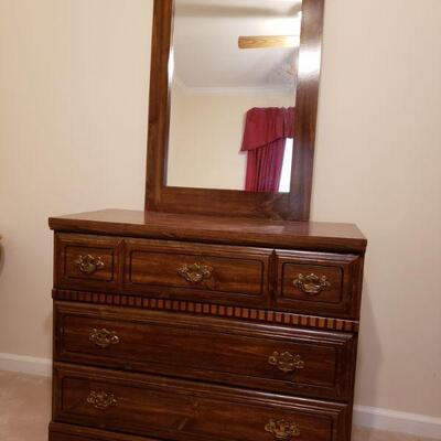 https://ctbids.com/#!/description/share/700507 Smaller wooden dresser with mirror and brass pulls.
Measures 37