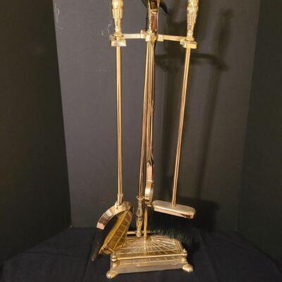 https://ctbids.com/#!/description/share/700666 5 piece brass fireplace tool stand. Includes poker, dustpan, broom and a wood grabber.
