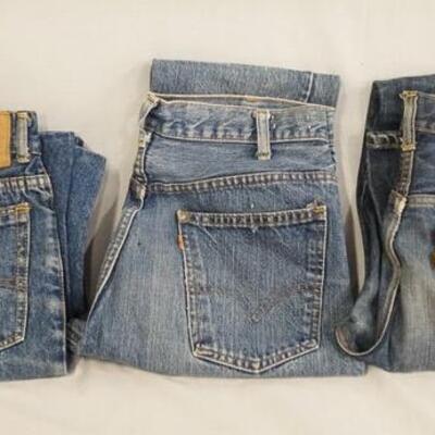 1092	LOT OF THREE PAIRS OF LEVIS JEANS W/ BIG E & ORANGE TABS. TWO PAIRS ARE FLARE & WAISTS MEASURE APP. 30 IN & 32 IN. THE THIRD PAIR IS...
