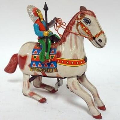 1187	ANTIQUE TIN WIND UP TOY INDIAN CHIEF RIDING HORSE, 1 LEATHER EAR MISSING ON HORSE, SPRING GOOD MARKED HAJI JAPAN	50	100	25	PLEASE...