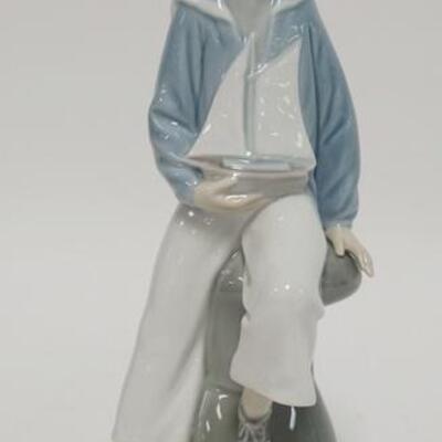 1067	LLADRO SAILOR BOY HOLDING A SAILBOAT, 9 IN HIGH
