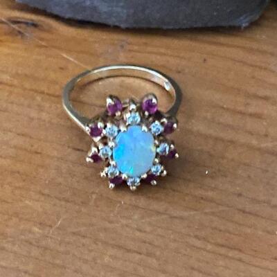 Opal Ring with Diamond’s & Ruby’s, 14 karat yg
yellow gold size 6 1/2 to 7 and 4.6 grm total weight.