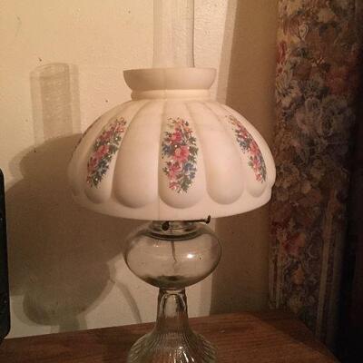 Appears to be a kerosene lamp that has been made into an electric lamp. Comes with glass globe and measures 11 in round and 21 in tall.
