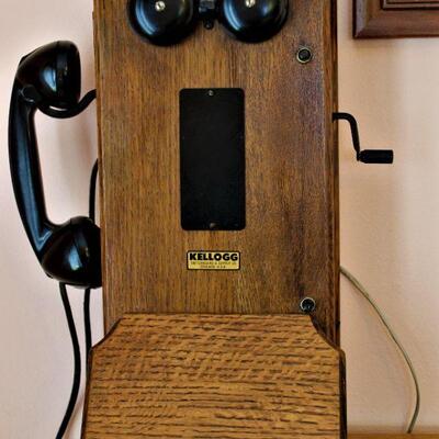 Antique Kellogg rotary phone with hand crank.  Oak cabinet.