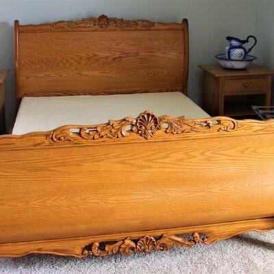 Ornately styled queen sized bed set with box springs is beautifully crafted.  Solid oak.